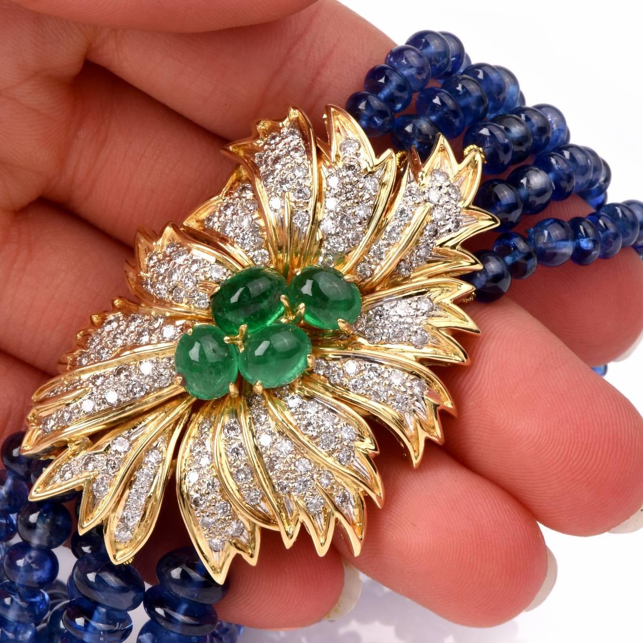 This opulent estate necklace comprising 5 strands of graduated genuine blue sapphire beads and an 18K yellow gold floral motif decor  weighs 121.3 grams and measures 19.5