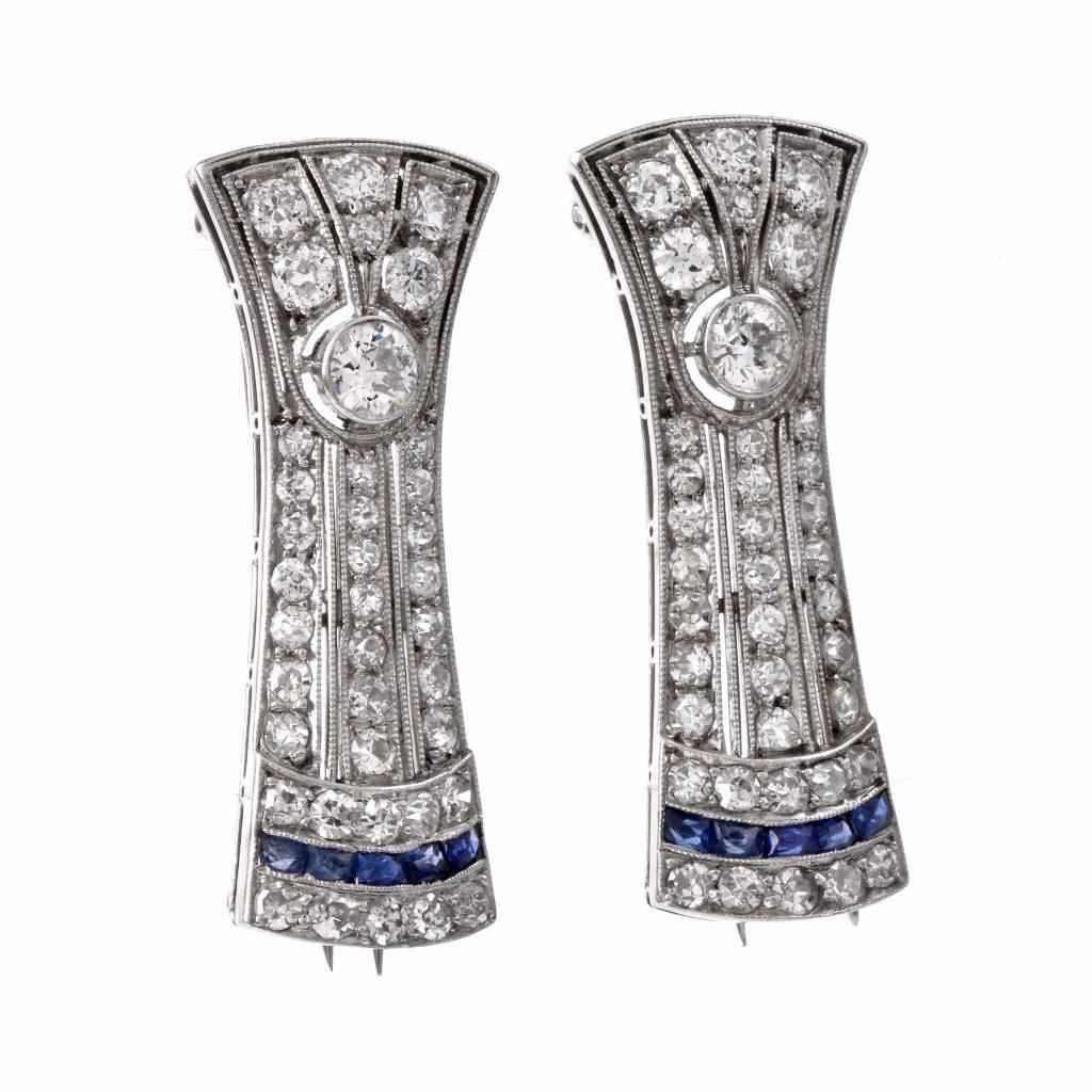 These alluring antique deco lapel brooches of delicate linear design are crafted in platinum and weigh together 13.00 grams. The diamonds adorning this set of pins weigh cumulatively 1.57cts, graded G-H color VS clarity, mounted within artfully