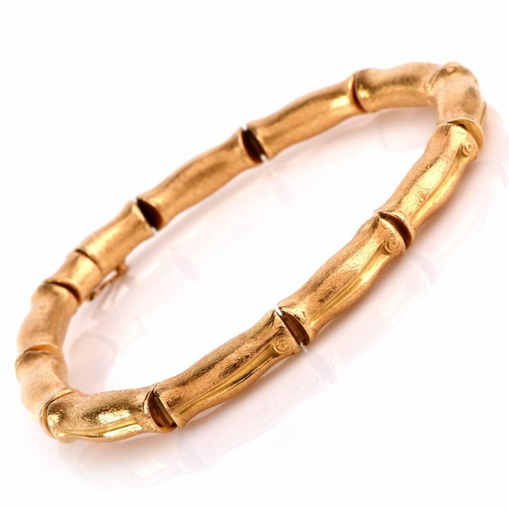 This alluring vintage bracelet is crafted in solid 18K yellow gold. Comprising 11 flexible bamboo links rendered in finely matted textured gold. It weighs 19.2 grams and measures 8