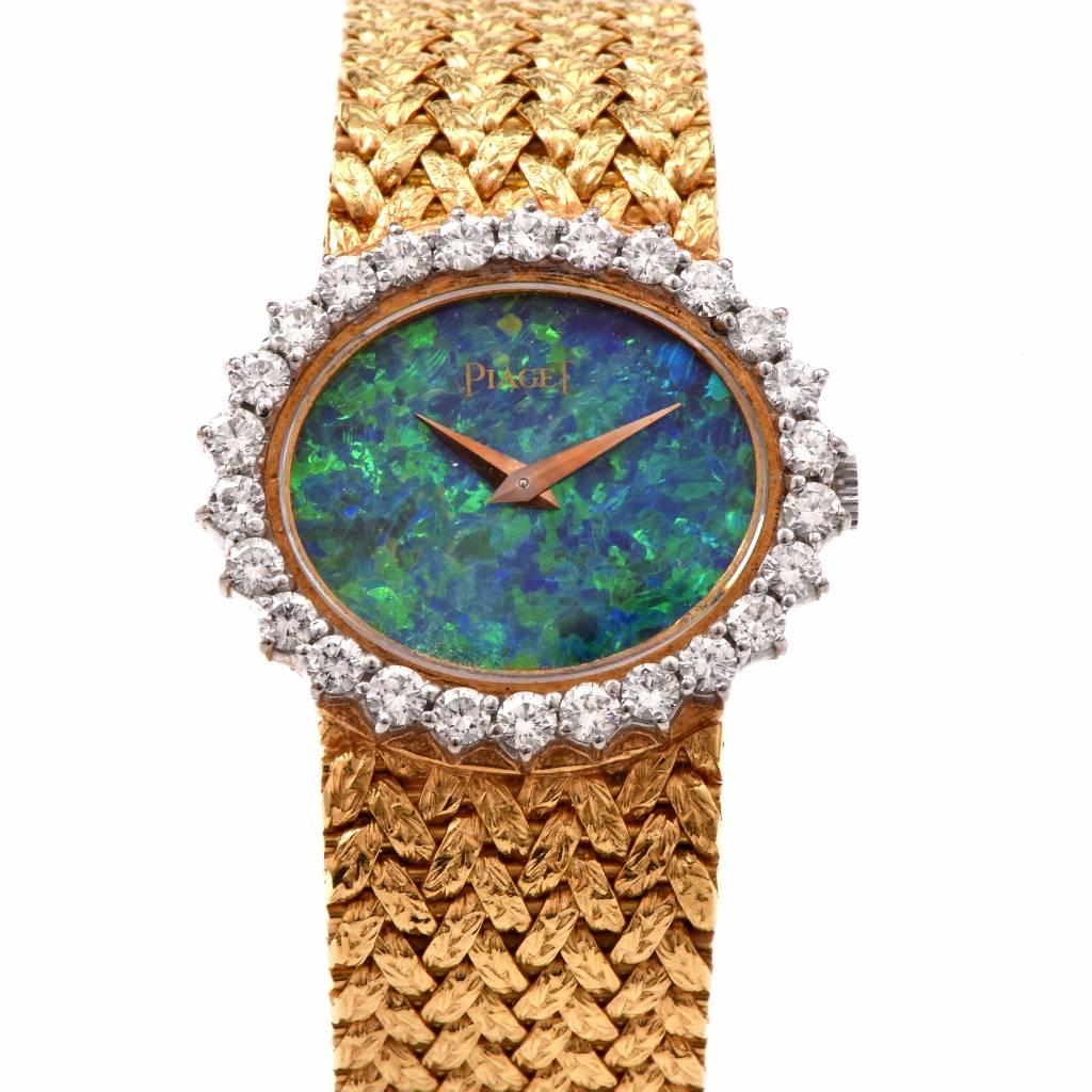 Circa 1970s  18K Yellow Gold vintage Piaget Ladies Wrist Watch, Manual Wind movement, solid genuine factory set very rare genuine opal dial ( in Mint condition) with signed 'Piaget' watch case measures 27mm by 24mm  and 6