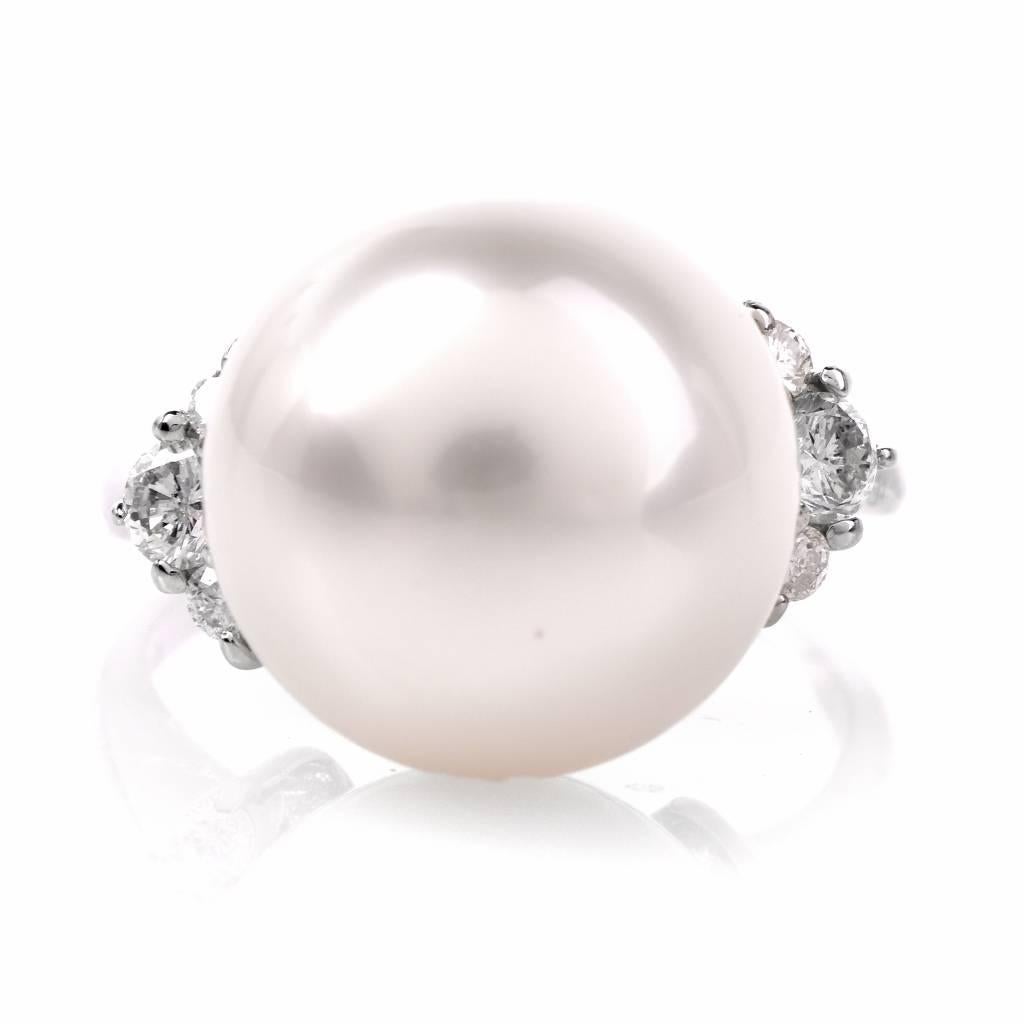 This alluring South Sea pearl and diamond cocktail ring is crafted in solid platinum and weighs 7.7 grams. This classically distinct and timelessly in vogue cocktail ring exposes a lustrous 13 mm South Sea pearl of ‘white with a pinkish hue’ color. 