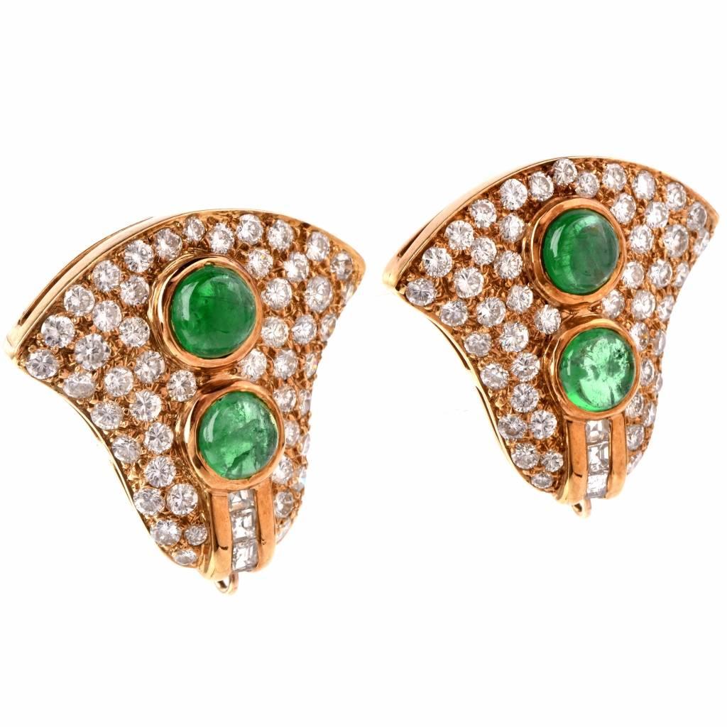 These vibrant Retro clip-back earrings with emerald cabochons and diamonds are crafted in solid 18K yellow gold, weighing 19.5 grams and measuring 25mm long and 25-13 mm wide.  These earrings expose each a pair of genuine emerald cabochons, a total