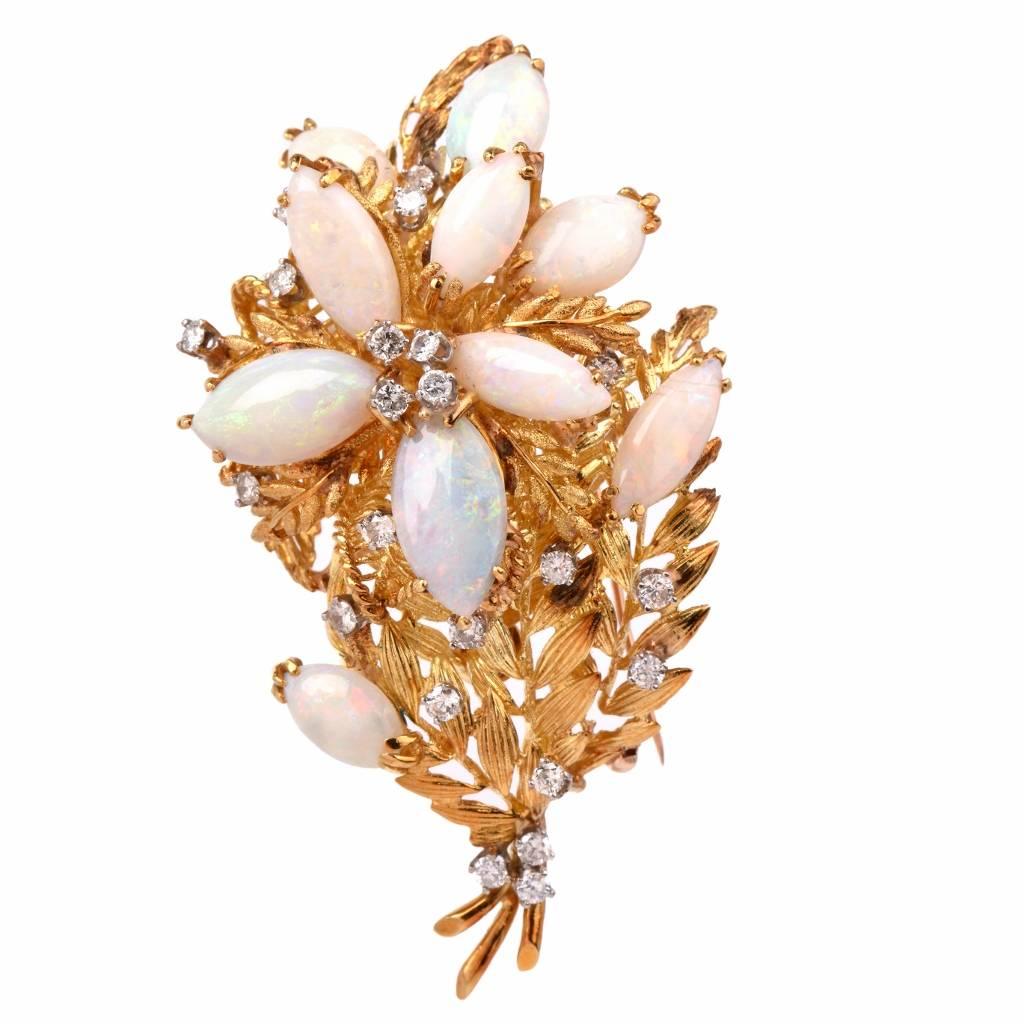 This vintage retro pin brooch of opulent aesthetic and meticulous workmanship is crafted in solid 18K textured yellow gold, weighing  55.7 grams and measuring 3.1” long and 1.1/2” wide x 24 mm deep. Designed as an attention-seeking floral spray,