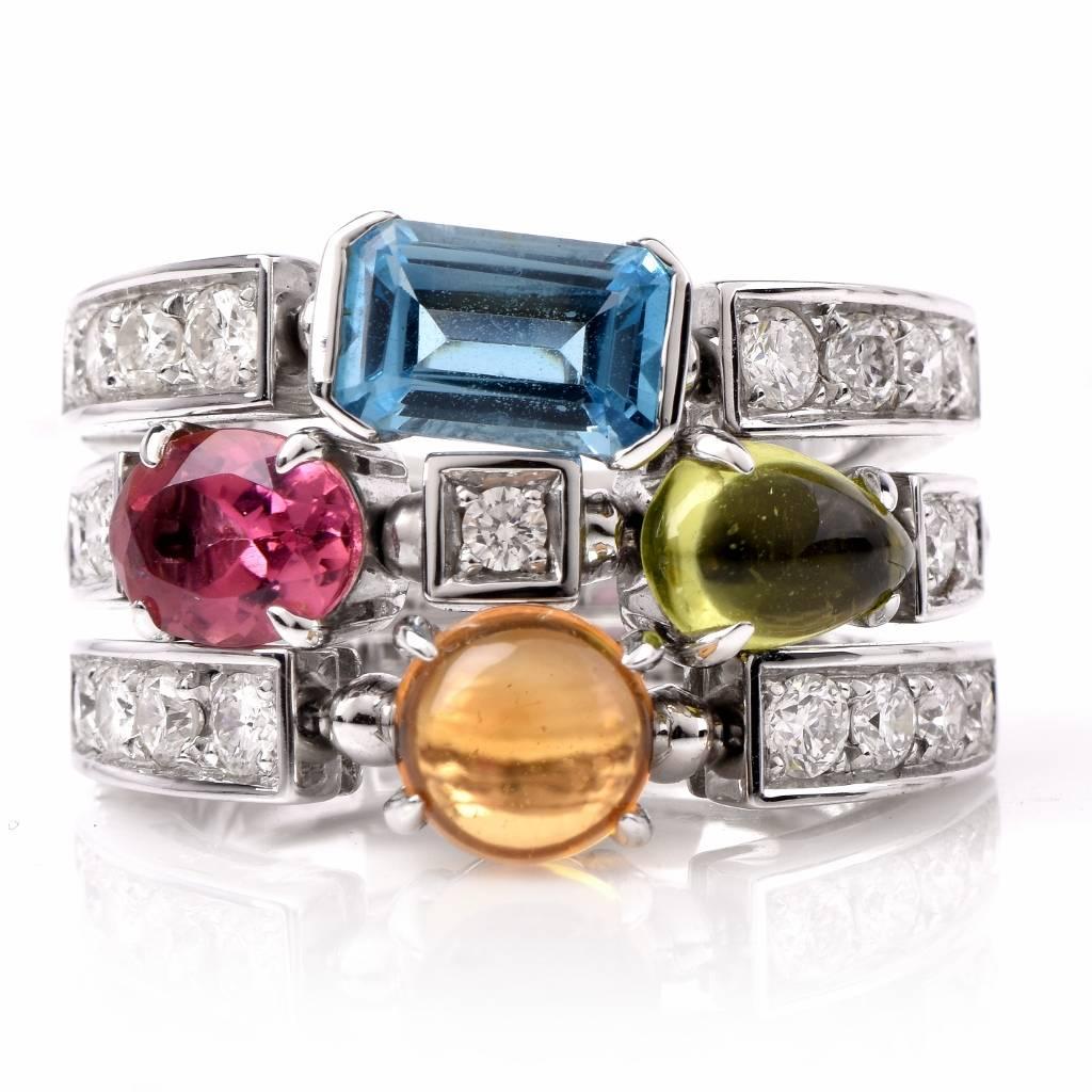 This vivacious Bvlgari multi-gem ring from the designer’s popular Allegra collection is crafted in solid 18K white gold, and  weighs 12.00 grams.  In immaculately crafted split design, consisting of three adjacent bands, the ring is adorned with a