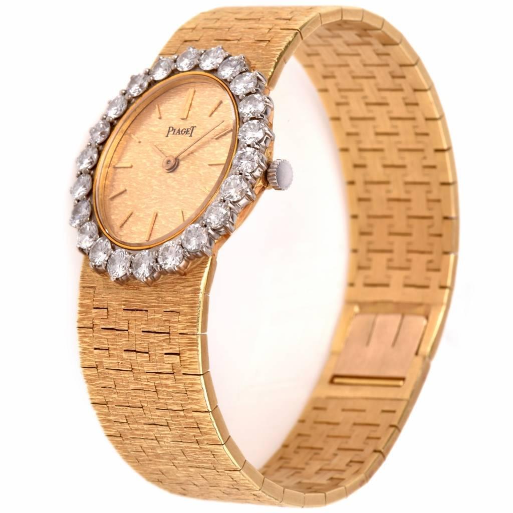 This authentic circa 1960 classic Piaget Ladies wristwatch with diamonds features an 18K yellow gold case, dial and integrated bracelet, the latter in finely textured gold, case measuring 28 mm x 25 mm and an oval-shape bezel adorned with 24 genuine