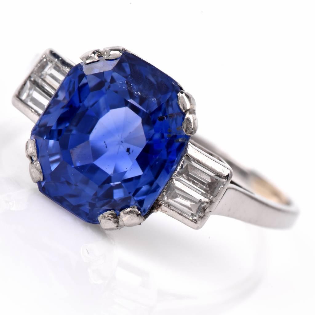 This alluring French antique engagement ring with a rare octagonal natural Ceylon blue sapphire and baguette diamonds is crafted in solid platinum and weighs 3.6 grams. The  AGL certified octagonal-cut blue sapphire of an enchanting vibrant royal