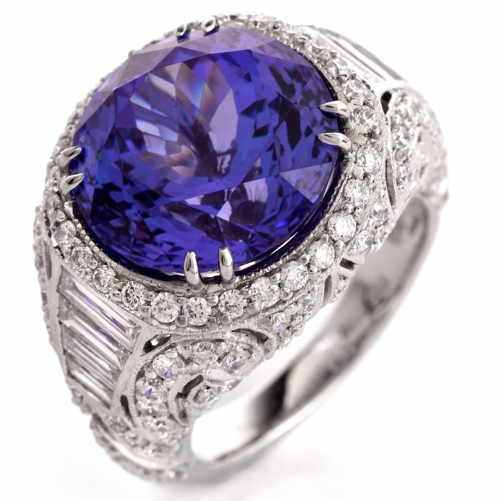 This sparkling estate cocktail ring is crafted in solid 18K white gold. Designed as a a subtly domed plaque, it's centered with approx. 12.66 ct translucent round-faceted tanzanite and secured by four paw-prongs.  The prominent center stone is