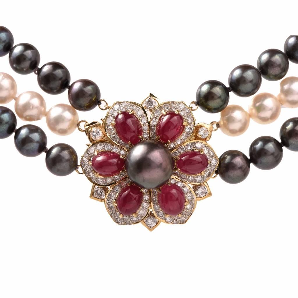 This elegant  pearl necklace incorporates 2 strands of Peacock pearls approx: 8.5mm, and one strand of lustrous off white with a pinkish hue color pearls approx: 9mm. It is secured with a highly ornate, floral motif detachable clasp and can be worn