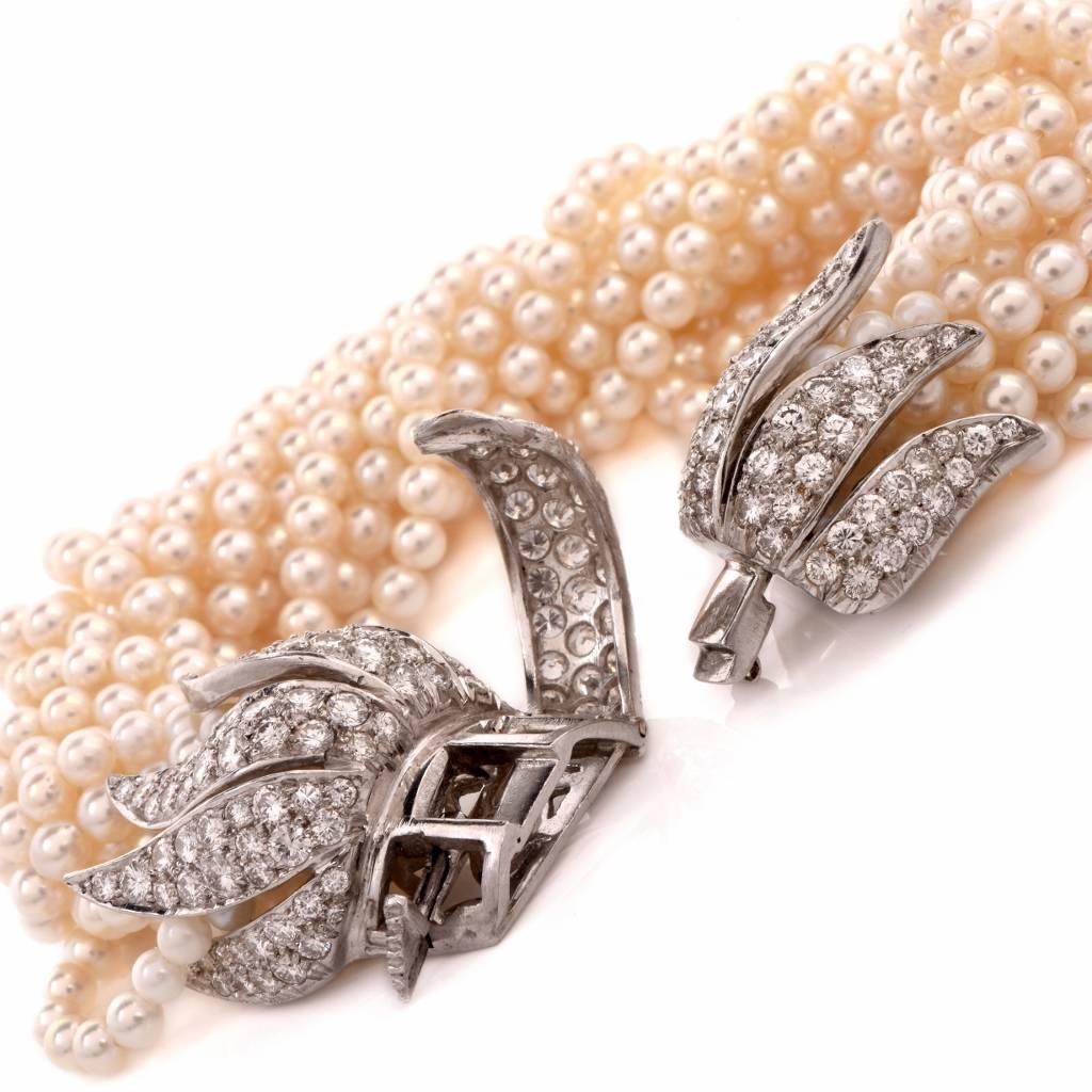 This very graceful and refined pearl and diamond multi-strand vintage bracelet with stunning diamond platinum clasp incorporates 13 strands of well-matched, silk-strung lustrous cultured pearls, measuring approximately 4mm in diameter with an