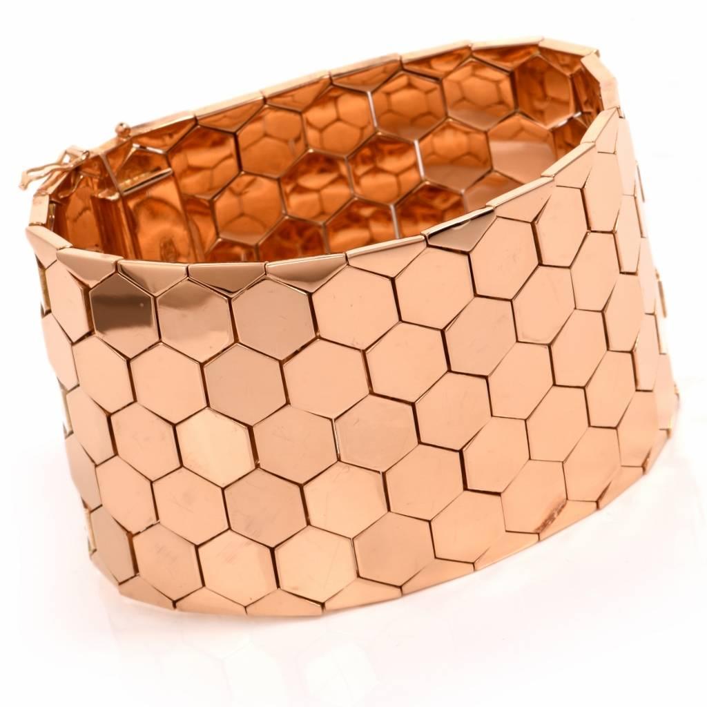 This classically distinct flexible wide vintage bracelet of quintessentially  Retro era is of European provenance, incorporating an assemblage of hexagonal honeycomb motif links, crafted in polished 18K rose gold. It measures approx. 7.75" long