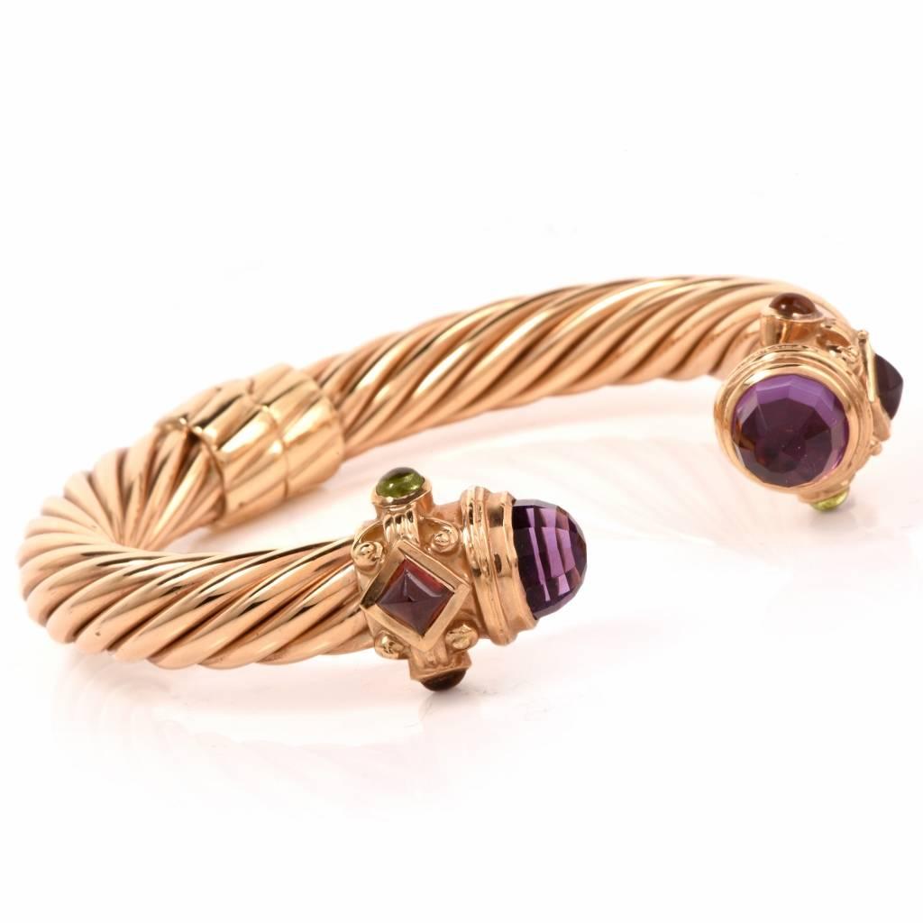 This elegant Estate twisted rope cuff bracelet immaculately made in solid 18K yellow gold. It is adorned with a pair of faceted fancy cut amethysts at each end approximately 7.75cttw. Complemented by two peridot cabochons, and a pair of cabochon