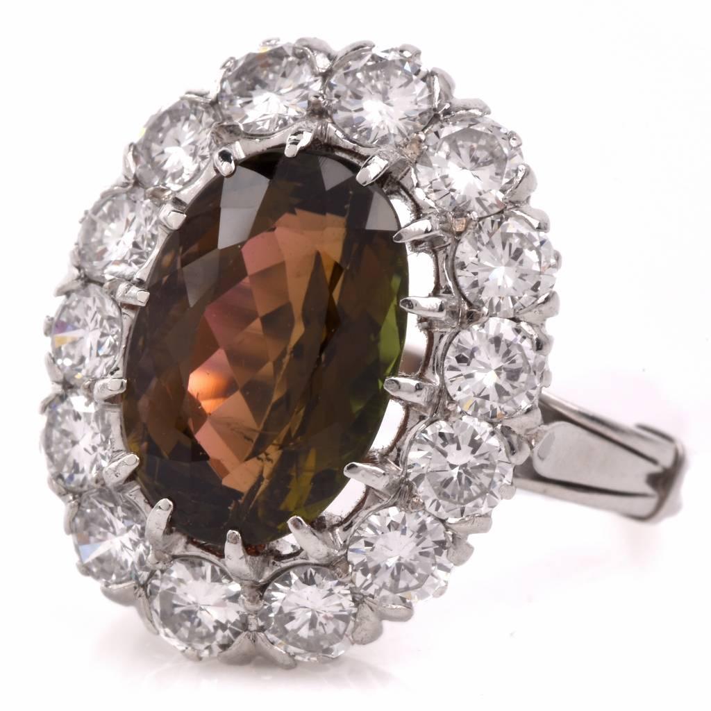 This vintage cocktail ring with a translucent 3.34ct oval-faceted collectible RARE brown-pink tourmaline and 14 round-faceted diamonds, is crafted in solid platinum. The sparkling genuine diamonds forming the perimeter of the oval plaque weigh