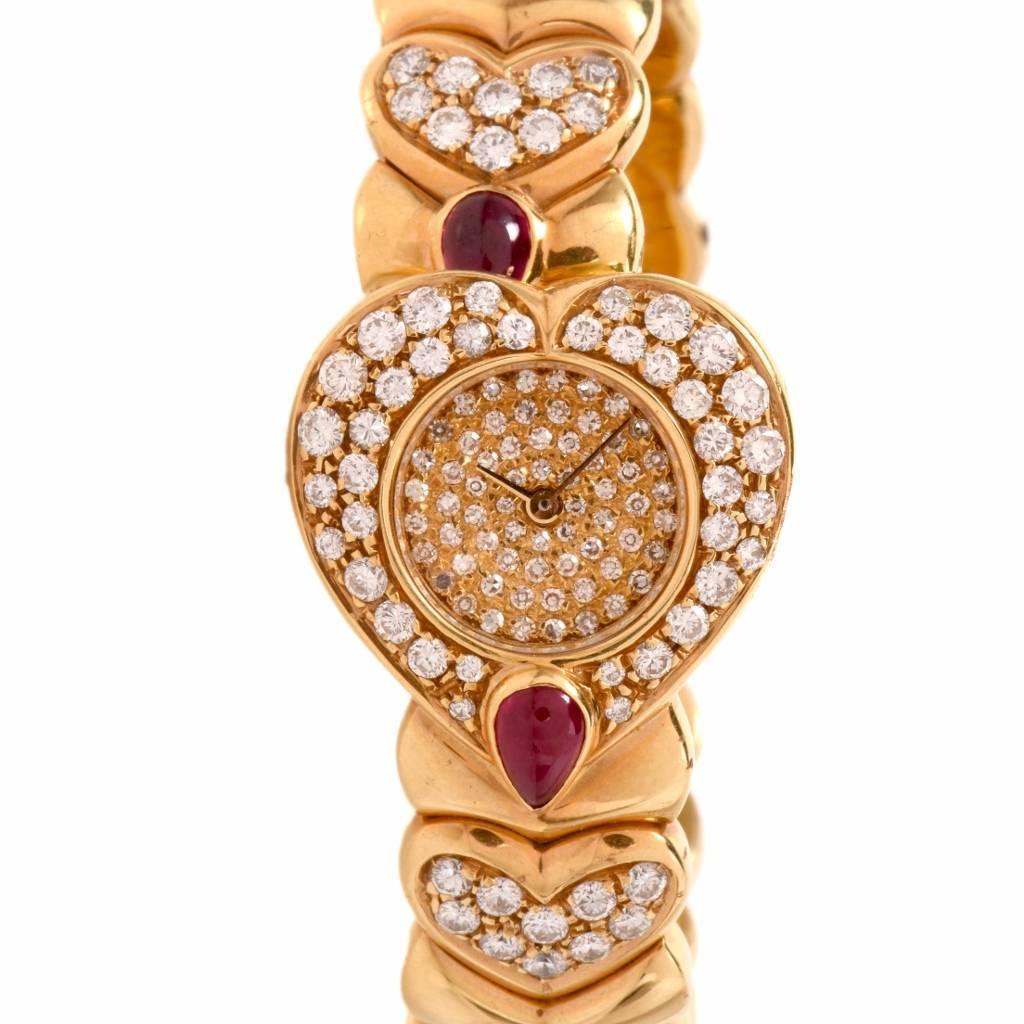 This highly ornamented cuff watch bracelet is crafted in solid 18K yellow gold. It incorporates a heart shape dial covered diamonds, diamond bezel. The cuff bracelet is composed by 4 heart motif profiles sparkling with pave-set diamonds. All