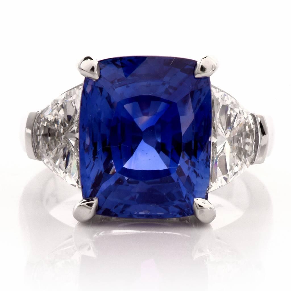 Extremely rare large natural Ceylon Sapphire and diamond ring crafted in solid platinum. It exposes at the center a natural no heat cushion modified cut sapphire of royal blue color, very rare, weighing approx. 11.53cts. This spectacular