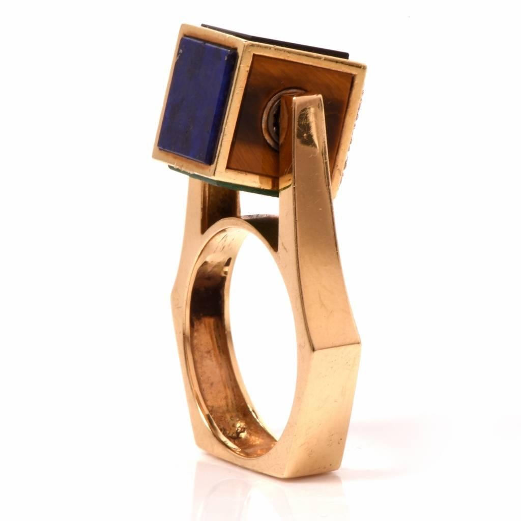 This retro ring with a bold design is crafted in solid 18K yellow gold. It features a rotating dice profile adorned with pave set diamonds approx. 0.30ct, graded H-I color and VS2-SI1 clarity, a square-cut lapis lazuli, malachite, tiger eye and