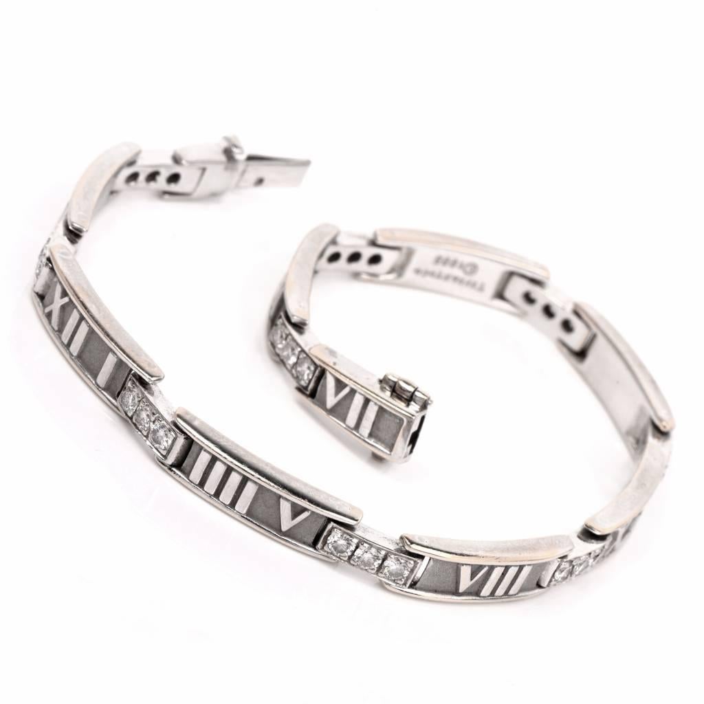 This timeless link bracelet from Tiffany & Co. 'Atlas' collection is crafted in 18K white gold and exposes roman numerals all around, adorned with 27 round cut genuine Tiffany diamonds of approx. 1.20cttw, graded F-G color, VVS1-VVS2 clarity. This