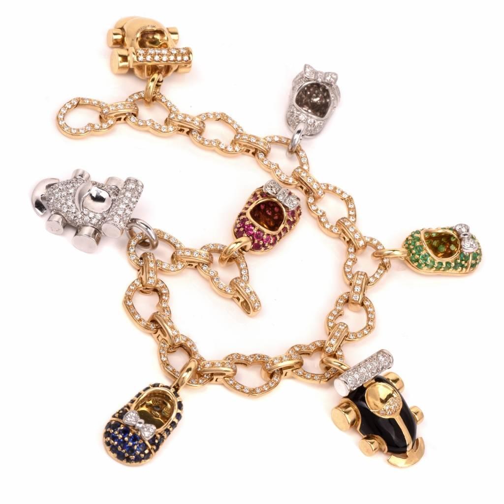 This very fine designer charm bracelet is crafted in solid 18K yellow and white gold, comprising diamond studded heart motif links covered with round diamonds and adjoined by oval ringlets. The bracelet is complemented with 7 baby shoe charm