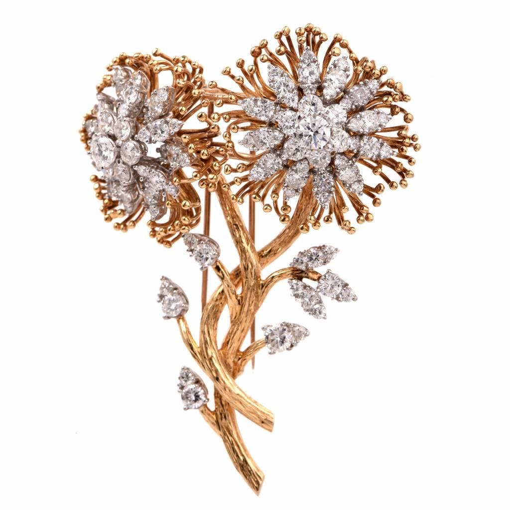 This stunning brooch/pin is crafted in solid 18K yellow gold. This charming piece exhibits two detailed flowers with genuine round cut diamonds, of approx. 6.62ct, G-H color, VS1-VS2 clarity, set in solid 18K white gold. This cluster pin/brooch is