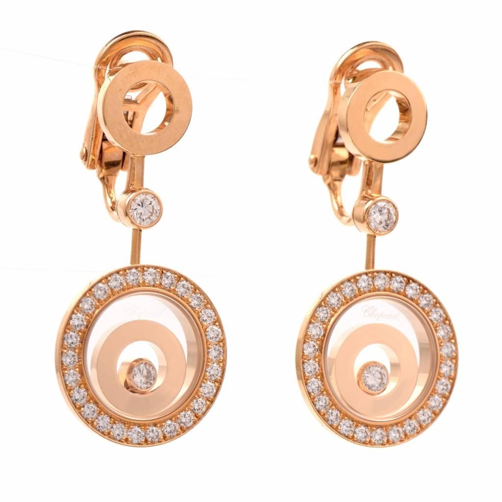 These feminine lovely Chopard drop earrings from the 'Happy Spirit' Collection are crafted in solid 18K yellow gold, weighing 21.5 grams. It is decorated with one genuine round cut Diamond and 2 floating concentric circles encased in the pendant,