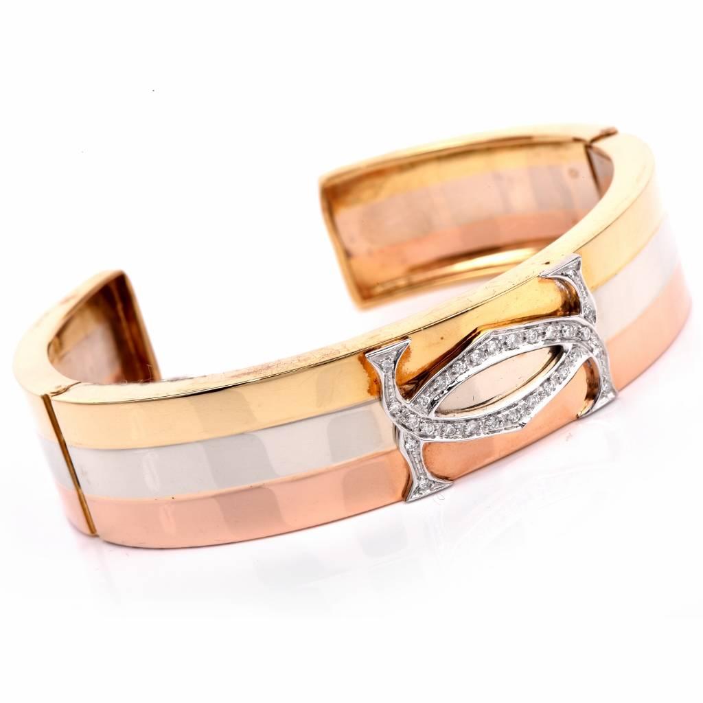 This elegant cuff bangle bracelet combines 18K yellow, white and rose gold. It weighs 40.6 grams and measures 7