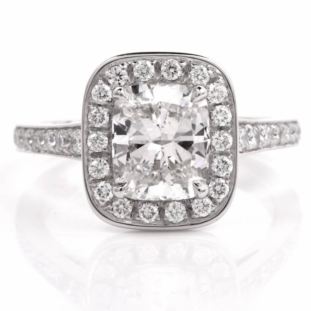 This beautiful diamond engagement ring is crafted in solid platinum exposing at the center a GIA graded cushion cut diamond weighing approx. 2.02cts, graded G color and SI1 clarity, measuring 8.00 x 6.67 x 4.6mm, prong set. The sparkling center