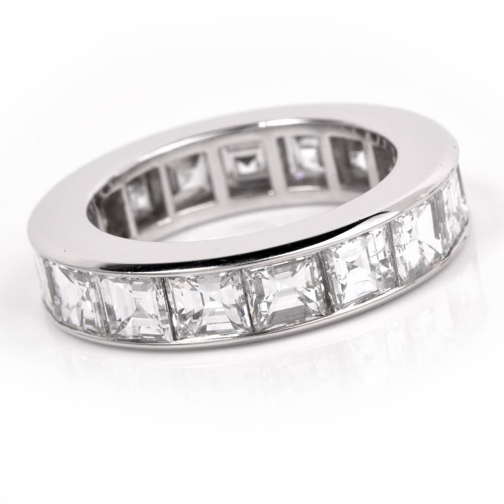 This classic hand crafted platinum eternity band weighs approx. 9.1 grams and is adorned with 17 genuine square Asscher-cut diamonds cumulatively weighing approx. 5.77cts, graded E-F color and VVS1-VVS2 clarity. This elegant eternity band ring is in