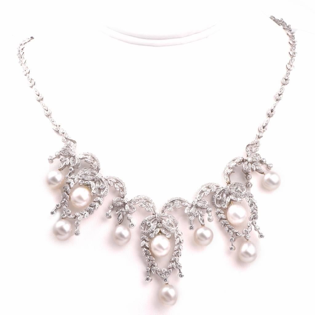 This diamond necklace of exquisite allure and feminine grace is crafted in 18k white gold and weighs approx. 73.4 grams. This elaborately detailed necklace incorporates an assemblage of 7 floral motif fringe pendants, the floral profiles being