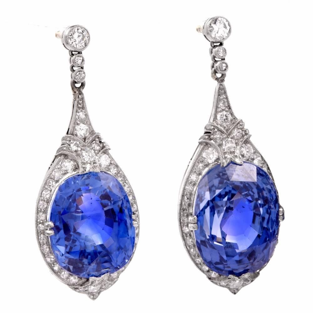 These spectacular antique art deco pendant earrings are crafted in solid platinum. They expose a pair of breathtaking GIA Certified RARE natural corundum.  These important natural Ceylon cushion-cut sapphires weighing 33.79cts in total and have NO