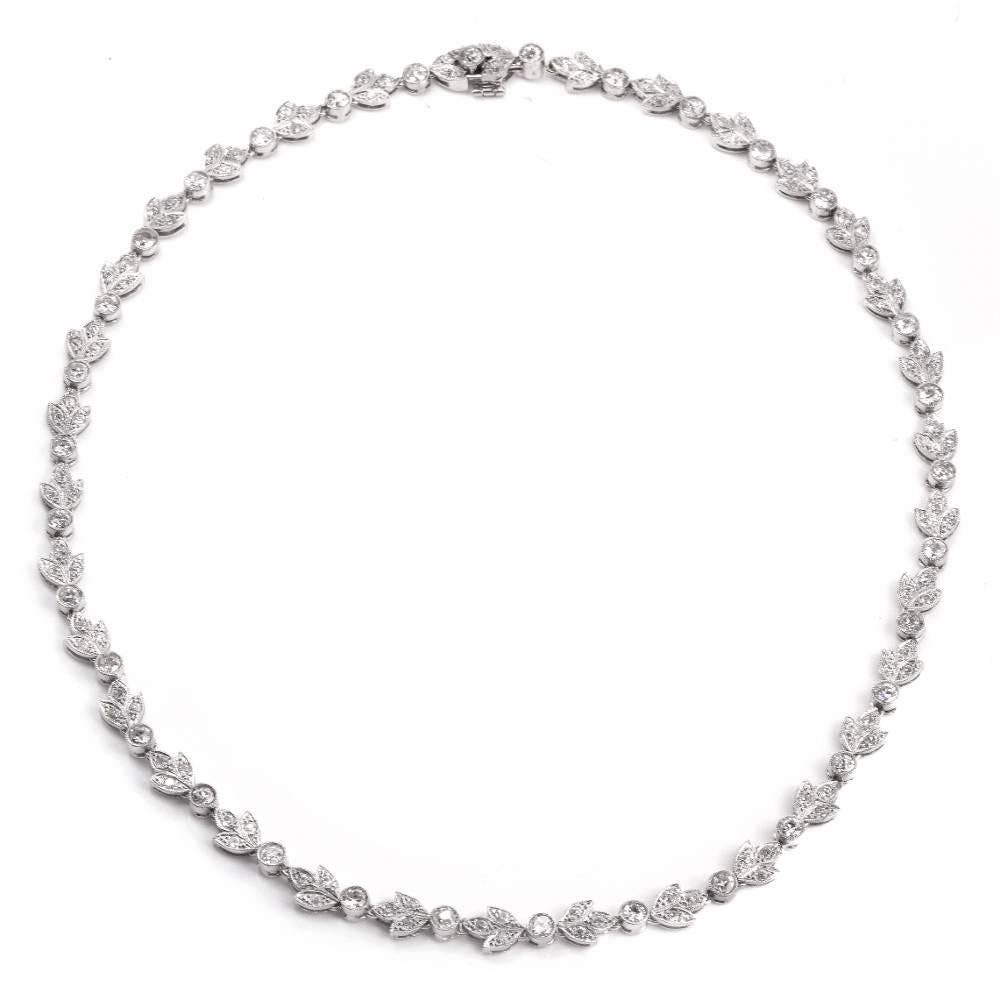 This antique Art Deco choker necklace of naturalistic design is crafted in solid platinum and incorporates an assemblage of enchanting diamond leaf motif  links, intersected by diamond collets. The genuine round old European-cut diamonds adorning