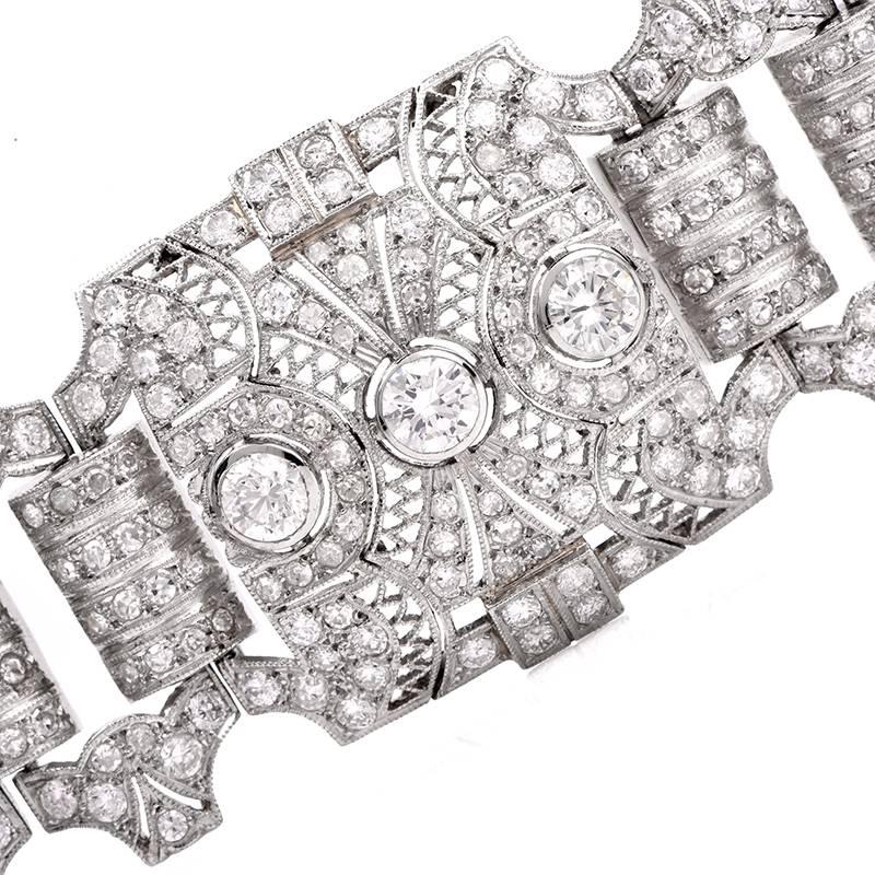 This sparkling antique Art Deco diamond bracelet with exquisite filigree enhancements is crafted in solid platinum. It incorporates 4 square filigree links centered with 12 round cut genuine diamonds weighing approx. 5.40cttw, G-H  color and 