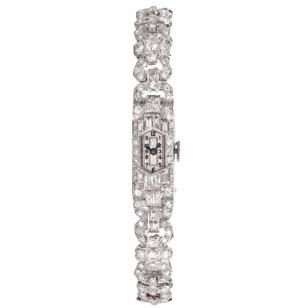 This ladies watch is crafted in solid platinum. The platinum filigree bracelet is accented with approx. 200 genuine round cut diamonds and 8 genuine baguette cut diamonds, all approx. 3.48cts, H-I color, VS2-SI1 clarity. This watch has a mechanical