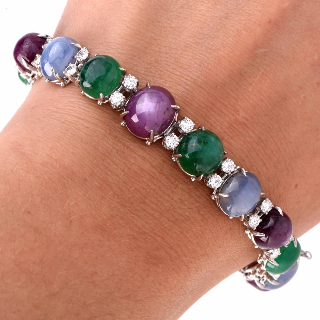 This vibrant estate multi stone bracelet is crafted in solid platinum. GIA* Certified, it features 5 cabochon genuine natural blue star sapphires no heat approx. 31.45cts, 5 genuine natural cabochon star rubies no heat approx. 35.63cts, and 5