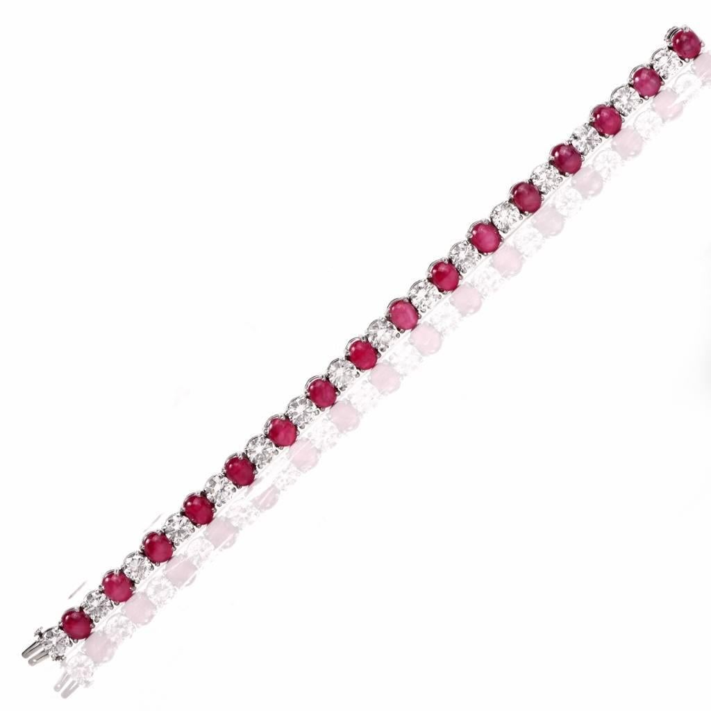 This vivacious Burma ruby and diamond bracelet is crafted in platinum. The alluring bracelet incorporates an assemblage of 16 oval cabochon natural star rubies all natural without ant treatments.( one of which has been randomly chosen by GIA