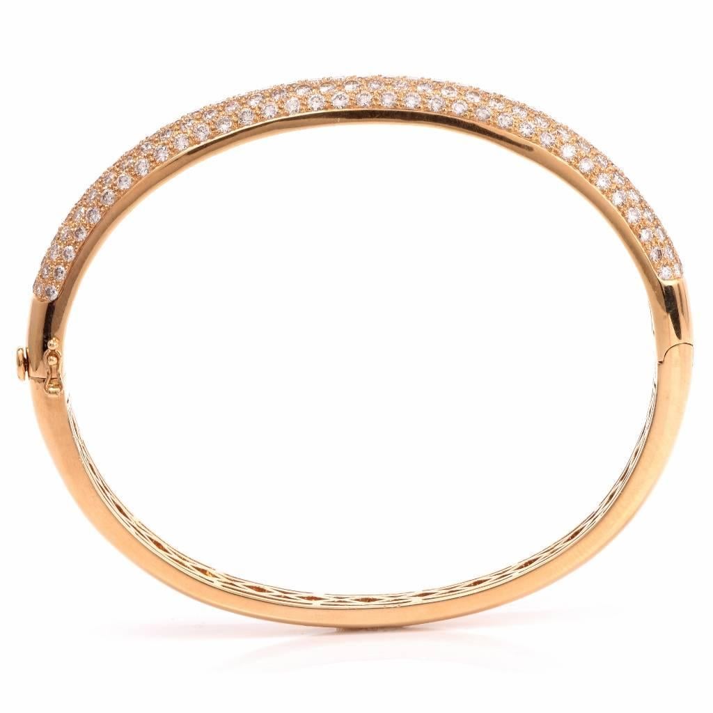 This Estate bangle bracelet of refined aesthetic is crafted in solid 18K yellow gold. Enriched with some 170 round diamond each approx. 16.38cts round-faceted pave set diamonds, graded H-I color, VS1-VS2 clarity, this bangle bracelets secure with a