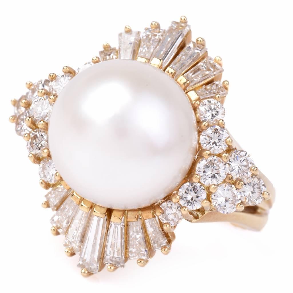 This impressive ring of popular ‘ballerina’ design is crafted in solid 18K yellow gold, weighing 12.2 grams and  measuring 24 mm wide. This alluring cocktail ring is centered with a lustrous cultured round pearl of cream white color, measuring 10mm
