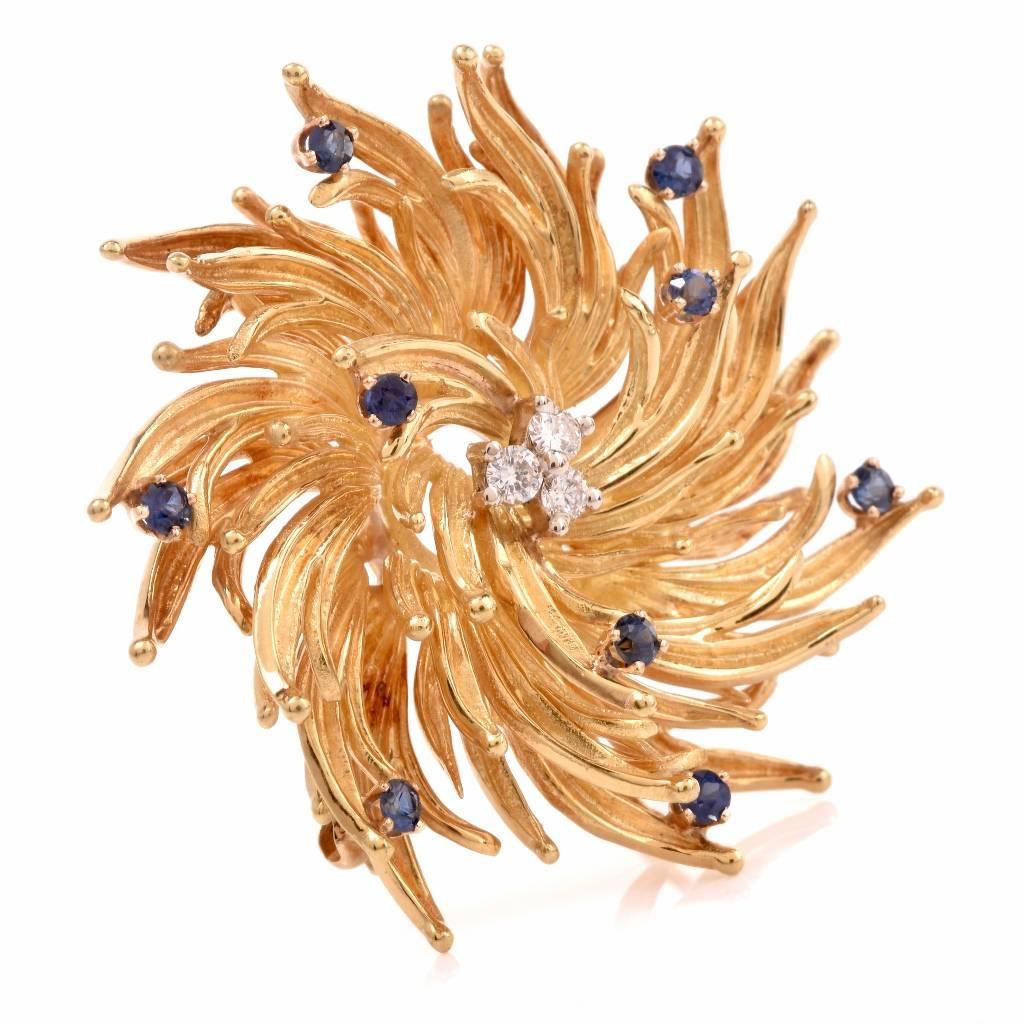 This estate Tiffany & Co. floral motif brooch of unmatched elegance is crafted in solid 18K matted and textured yellow gold, weighs 26.3 grams and measures approximately 42mm wide. This designer brooch incorporates a floral motif profile with