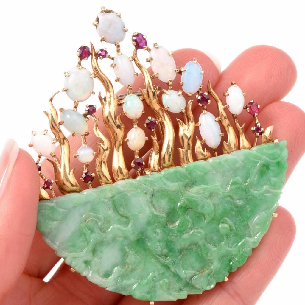 This vivacious antique English-made lapel brooch designed as a floral basket is crafted in solid 18K yellow gold. It incorporates a genuine jade basket a floral arrangement. It is adorned by 13 graduated opal cabochons with shimmering green, blue,