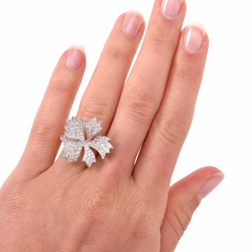 This fashionable 18K white gold flower ring shines from every angle encrusted with approx: 161 genuine round cut Diamonds approx: 1.59cttw, F-G color, VS1-VS2 clarity, pave set.

This beautiful timeless French made ring remains in like new