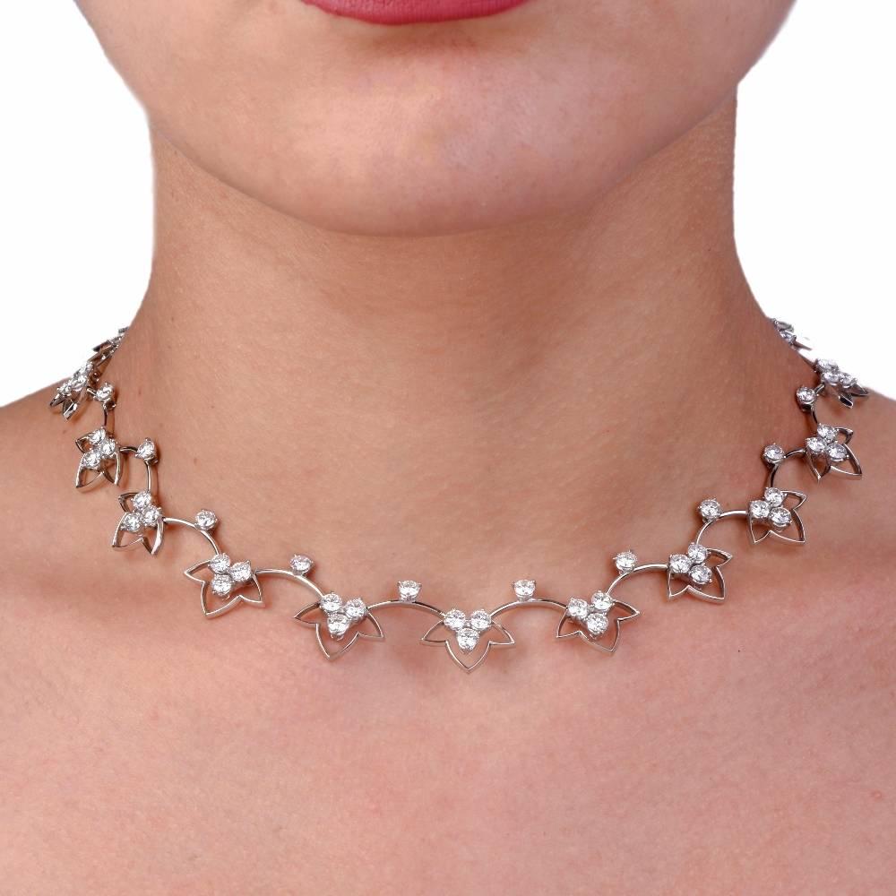 This elegant estate necklace features lovely flower designs crafted in solid Platinum. Encrusted with 75 high quality genuine large size round cut Diamonds approx. 14.38 carats , F-G color, VVS1-VVS2 clarity, prong set. This eye catching choker