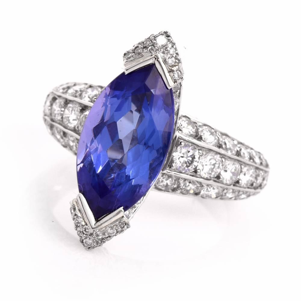 This impressive ring is crafted in solid platinum. It exposes a sizable marquise shape genuine tanzanite approx 4.39cts mounted within a diamond swathed canoe shape setting. This dazzling ring is adorned with approx.3.88cts of pave-set high quality
