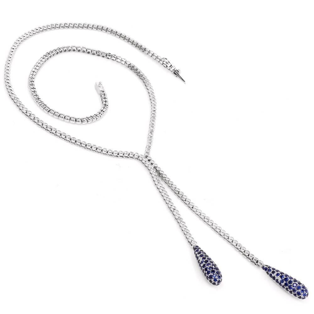 Crafted in solid `18K white gold, this twin tassel necklace is adorned with 1.65cts of high grade bezel-set round faceted diamonds, approx. G-H color, VS1-VS2 . The well-designed, color contrasting tassels are set with approx. 2.20 cts of genuine