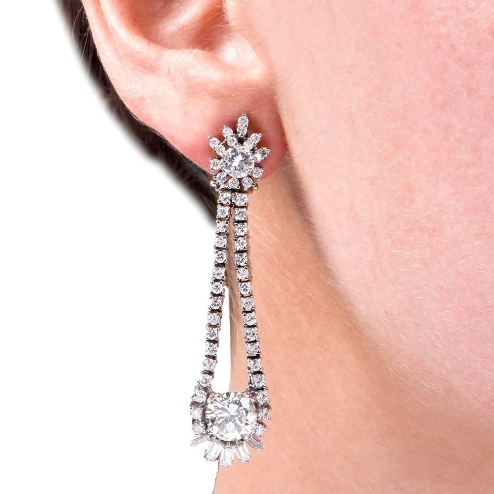 These exquisite 1960'S Platinum diamond chandelier earrings of affluent and sophisticated monochromatic aesthetic are inspired by stars and celebrities weighing approx. 17.2 grams. These grand chandelier earrings expose with 2 large round Brilliant