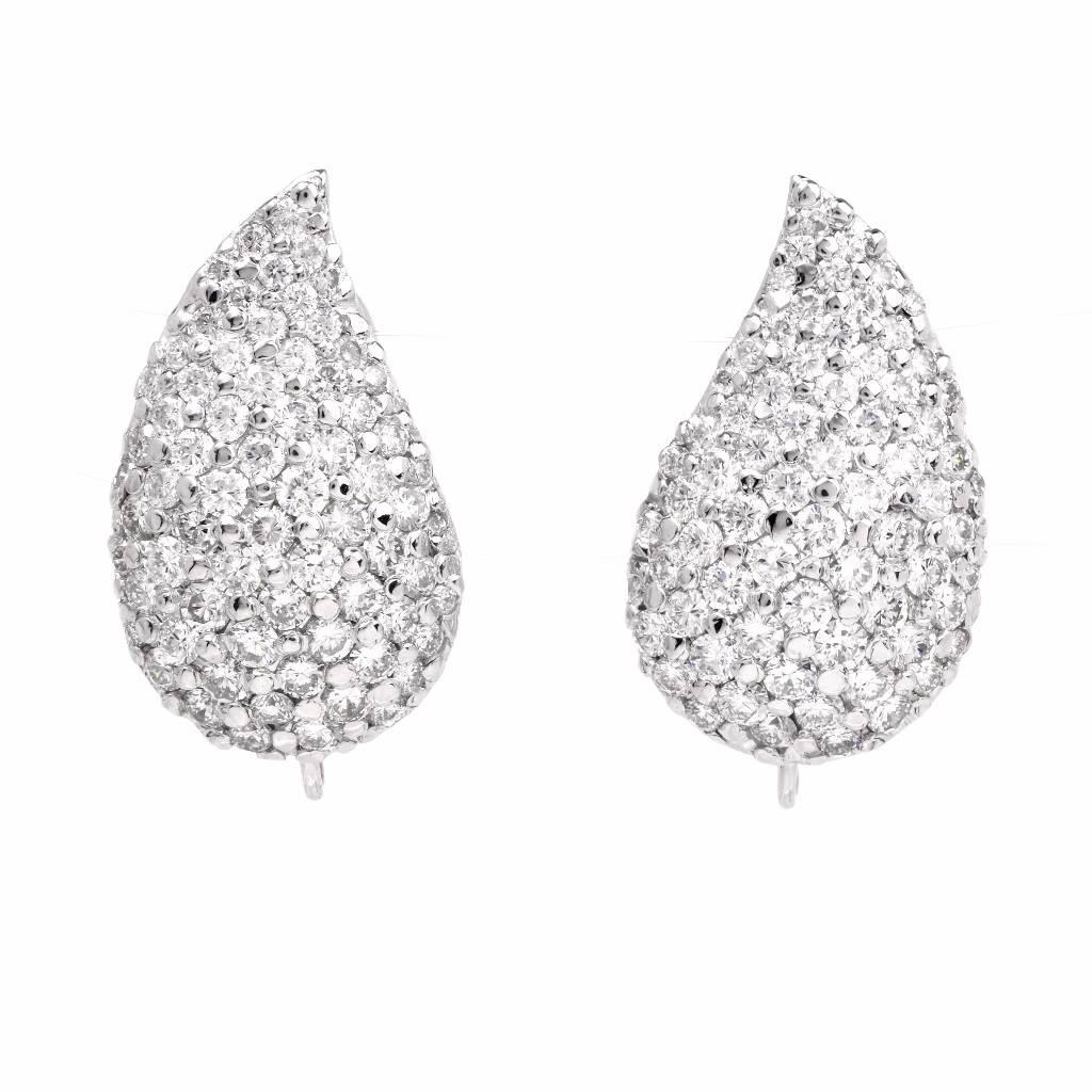 These timelessly elegant estate pendant earrings of sophisticated aesthetic are crafted in solid 18k white gold. Carefully hand crafted in two detachable parts, offering versatility. The top portions feature elegant leaf shape profiles, encrusted in