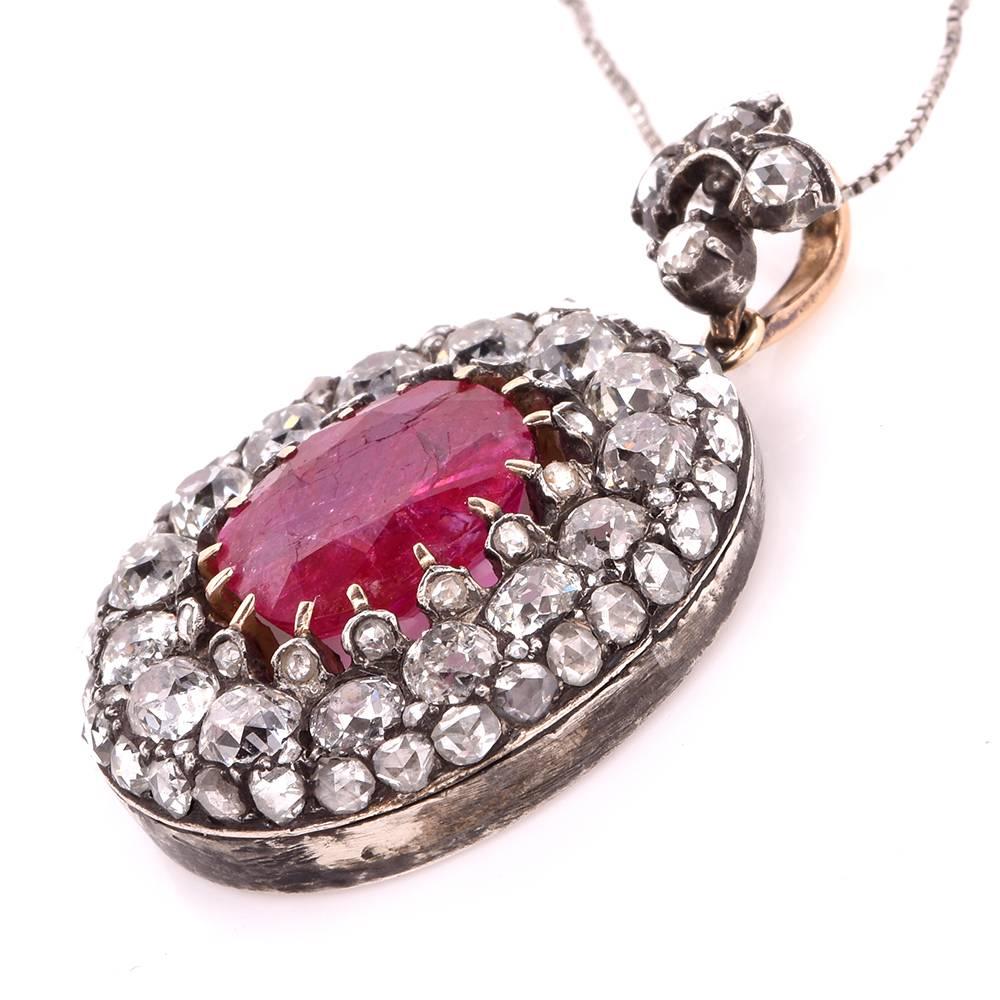 This Antique victorian diamond pendant of crafted in Silver and 15k Gold. This antique pendant is centered with one oval shape genuine ruby oval cushion-cut ruby approx. 5.00cts of Burma (Myranmar) provenance without any indication of heat,