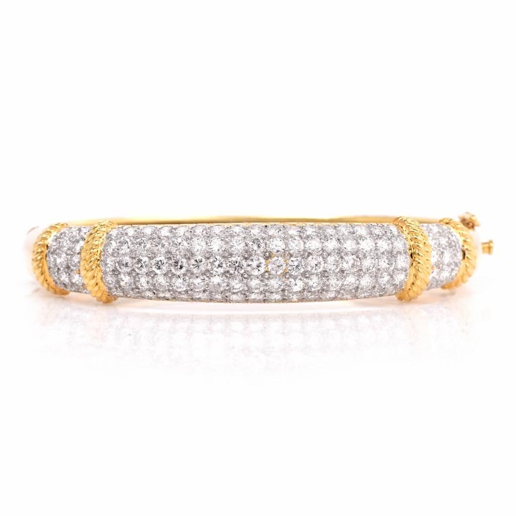 This stunning and stylish estate diamond bracelet is crafted in solid 18K yellow gold. This bracelet is accented with some 120 genuine pave set round diamonds approx 6.85 cttw, G-H color, VS1-VS2 clarity. With an insert clasp, this bangle bracelet
