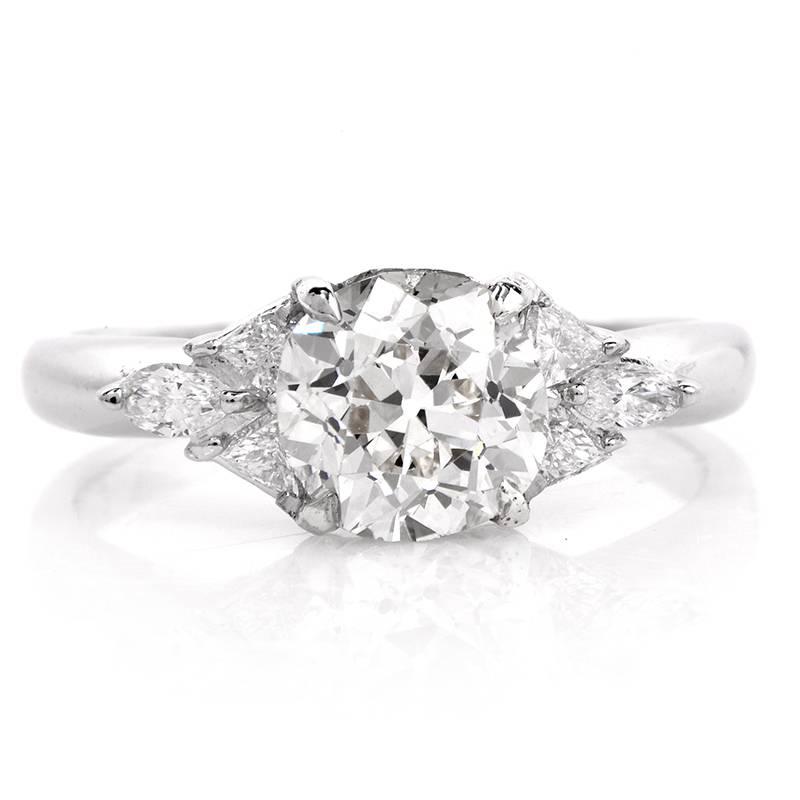 This estate diamond ring is hand crafted in solid platinum. Centered with an antique cushion cut diamond weighing approx. 1.91cts J color, VS1-VS2 Clarity. This ring is set with 4 triangular-cut and 2 Marquise cut diamond weighing approx.0.55cttw,