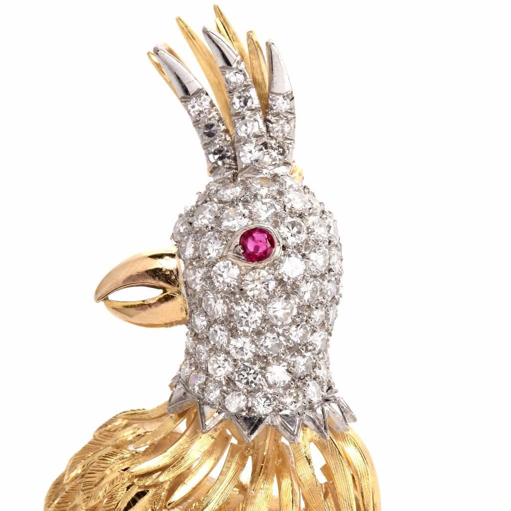 This elaborately detailed circa 1960’s brooch depicts the sculptured profile of a lovely parrot standing on a branch. The feathers show the artistic and realistic work of this piece. The bird’s head and tail are enriched with round-faceted diamonds,