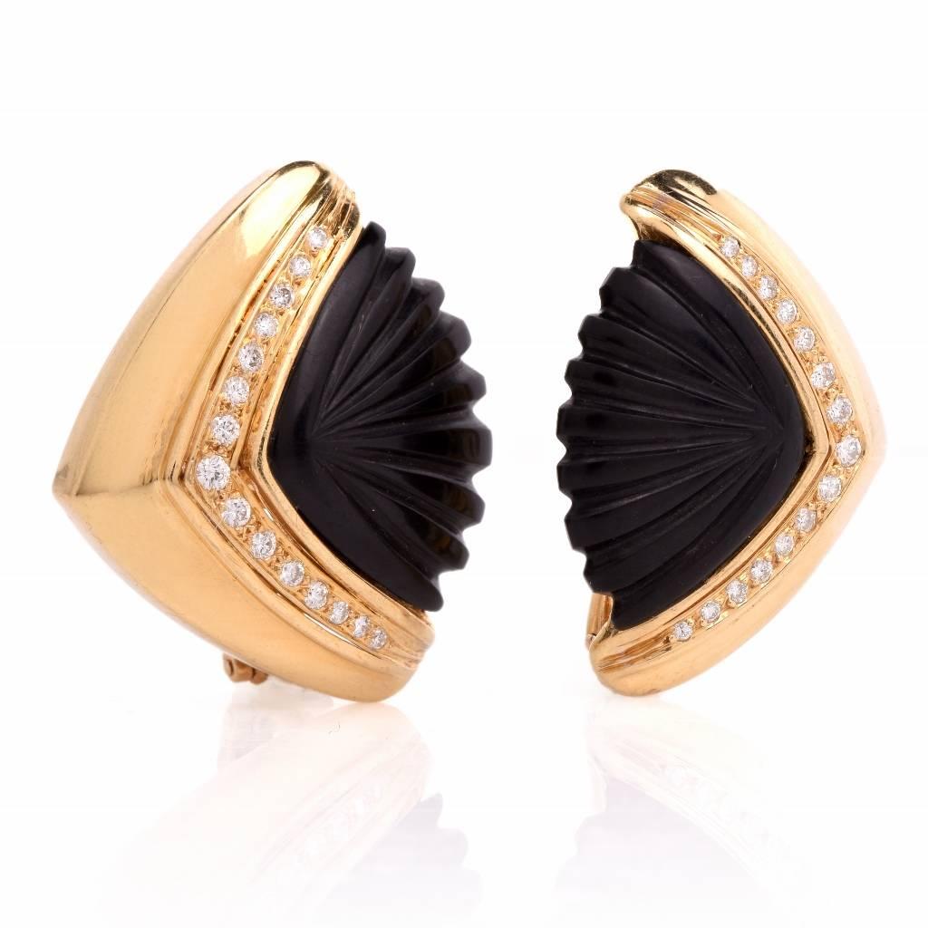 These estate diamond and onyx earrings are crafted in 18K yellow gold epitomize the art deco era design, weigh 22.5 grams and measure 32mm x 26mm. They incorporate a pair of carved black onyx and embellished with 34 pave set round diamonds, approx.