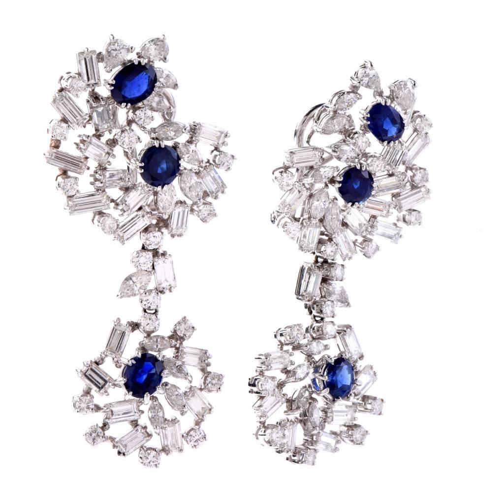 These elegant 1960's chandelier drop earrings are crafted in 18 karat white gold. Exposing a pair of diamond-swathed cluster profiles as ear clips. These exquisite earrings are adorned with 6 genuine oval and round cut sapphires approx. 3.05 carat