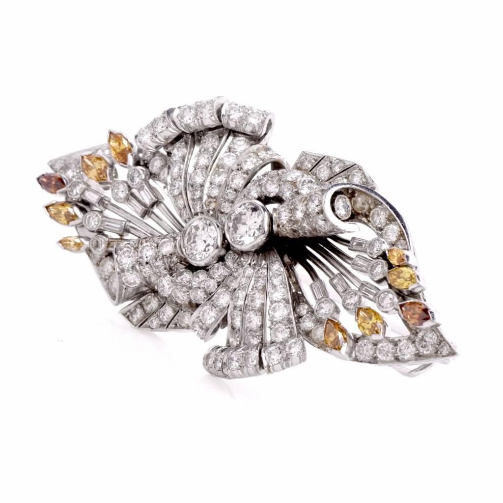 This elaborately detailed handcrafted vintage Deco lapel brooch crafted in palladium. It exposes two eminent round-brilliant diamonds at the center weighing approx. 1.60 cttw, H-I Color, VS1-VS2 clarity surrounded By 128 graduated round-cut diamonds